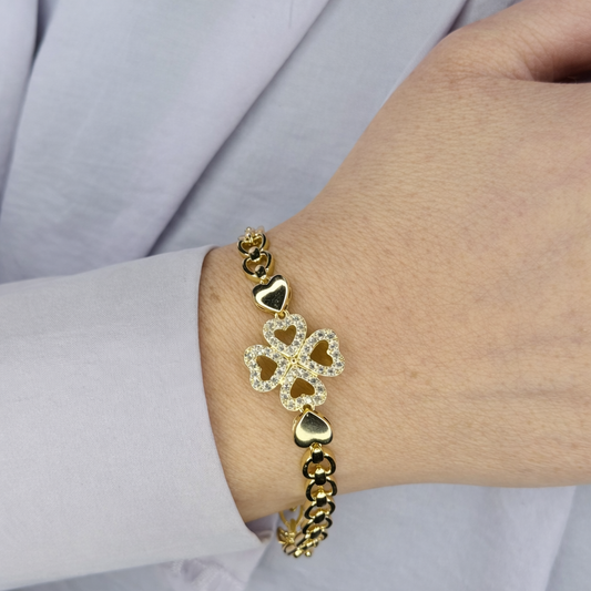 Gouden klaver armband met fonkelende zirkonia, gedragen om de pols – elegant dames sieraad met luxe uitstraling